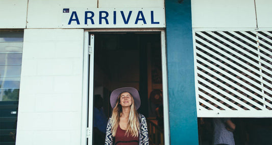 A girl in transit excited to do outdoor activities wearing a stylish hat from Conner Hats, longing for a natural, eco-friendly environment.