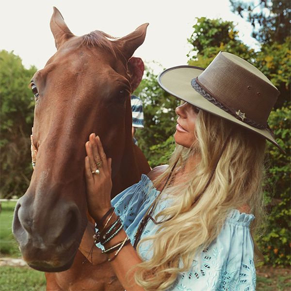 Woman wearing BC canvas hat with a horse
