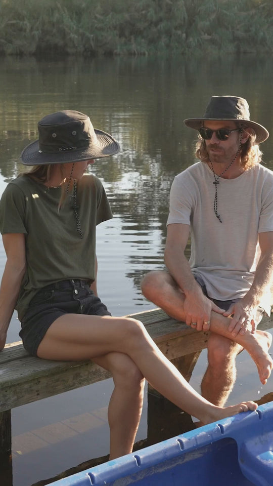 Murchasin River water resistant boating hat on the river