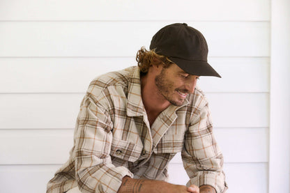 Man smiling in Kentucky oilskin cap by Conner hats