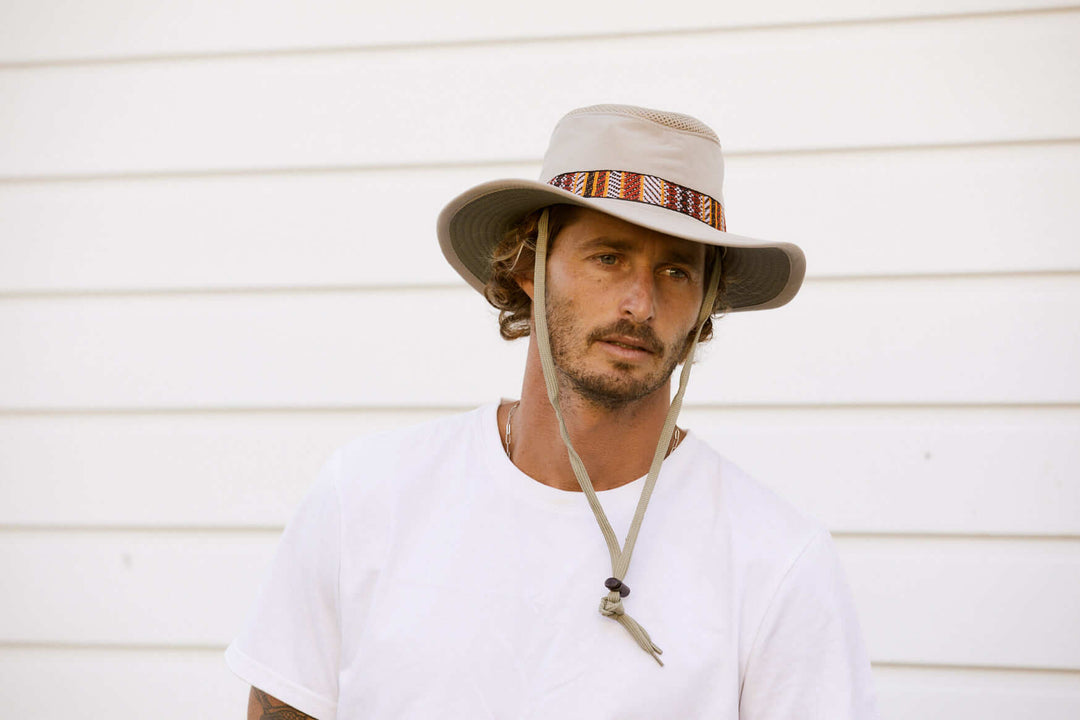 Man in recycled sailing boating hat with chin cord in Sand color