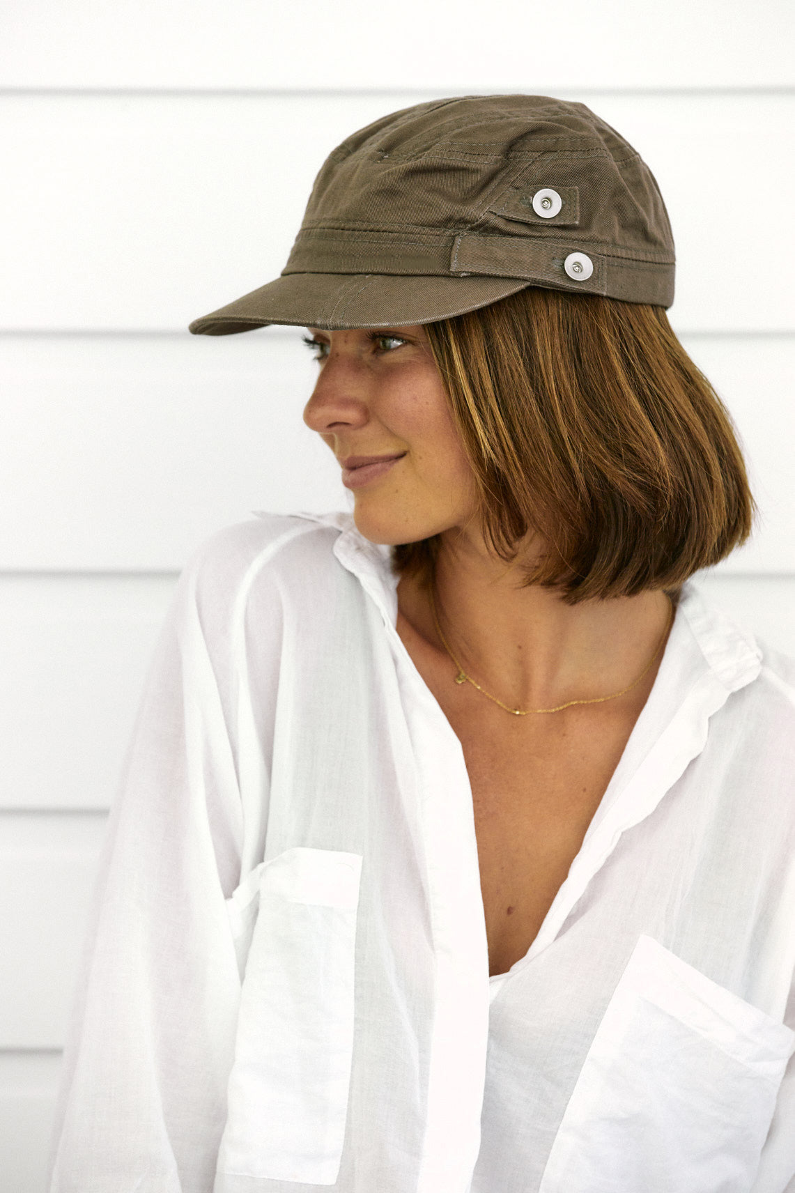 Woman profile in Olive organic cotton field army fatigue cap with silver buttons on side