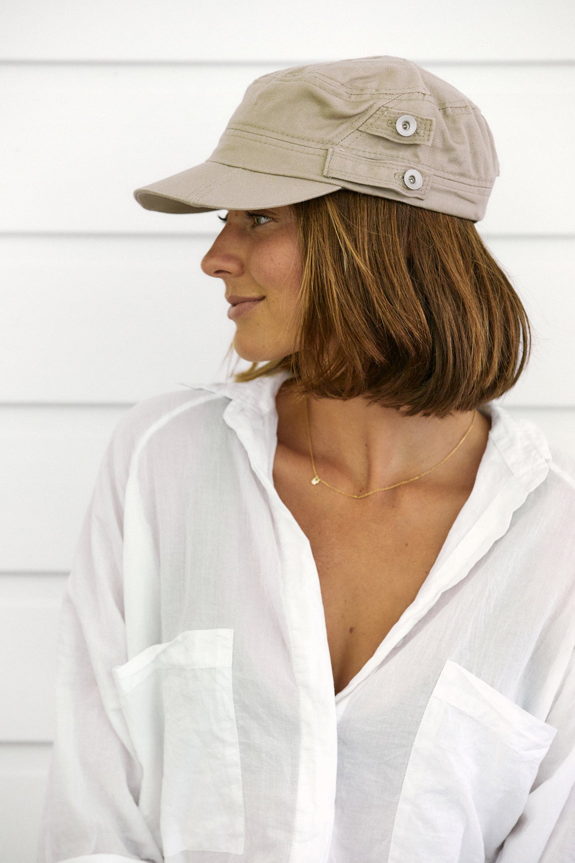 Woman wearing Khaki organic cotton field army fatigue cap with silver buttons on side