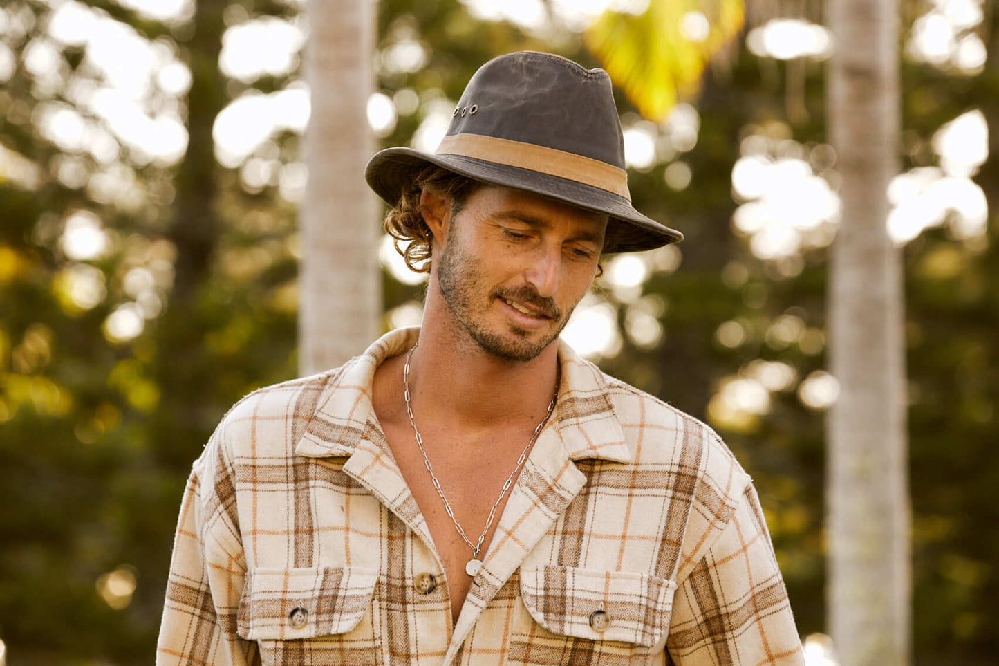 Man wearing outback hiking Hat with three eyelets and tan oilskin hat band