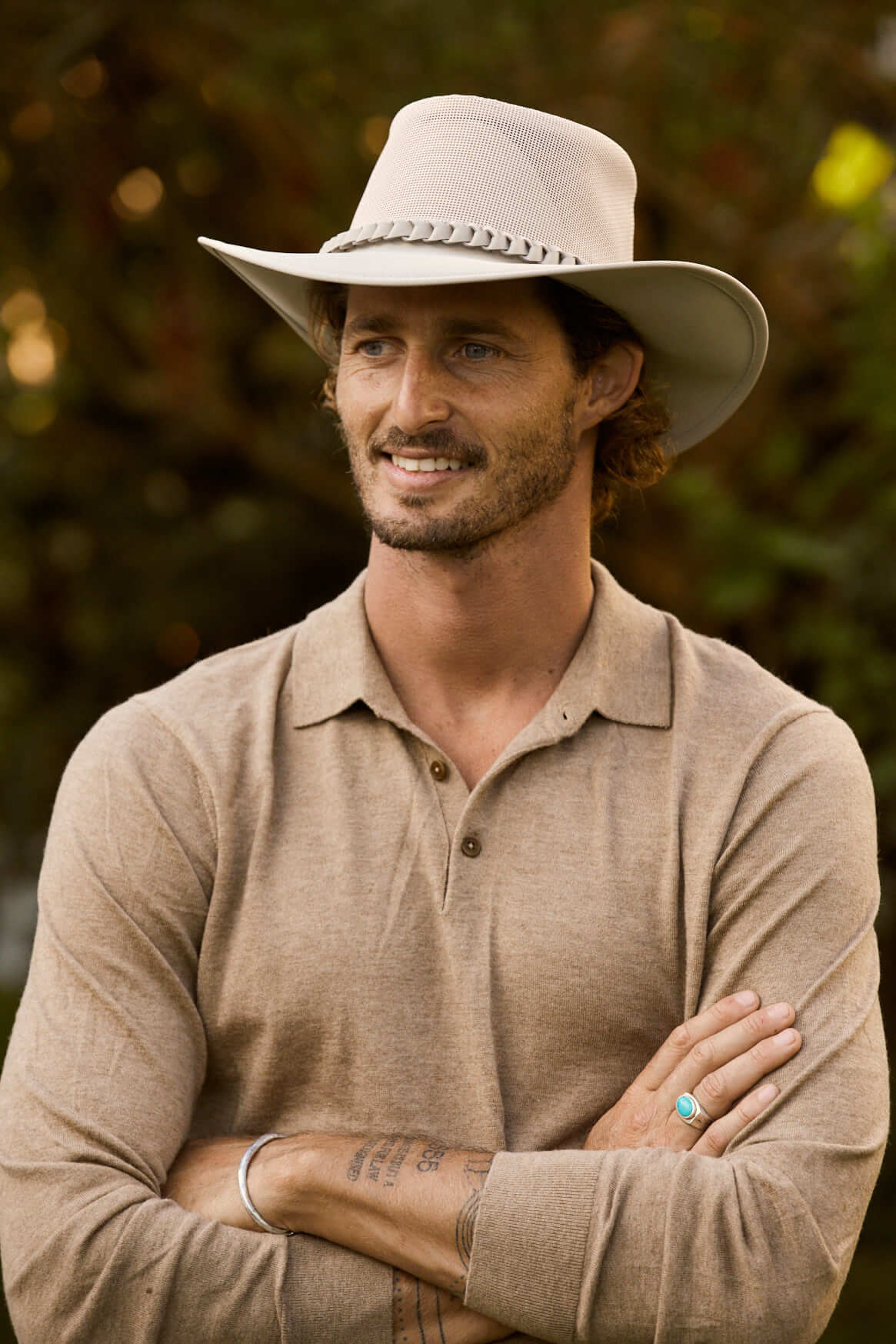Man in Aussie outback soakable golf hat showing mesh crown and sun protective brim in color Sand