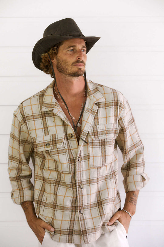 Man wearing outback style hat made from water proof wetahered cotton that looks like leather