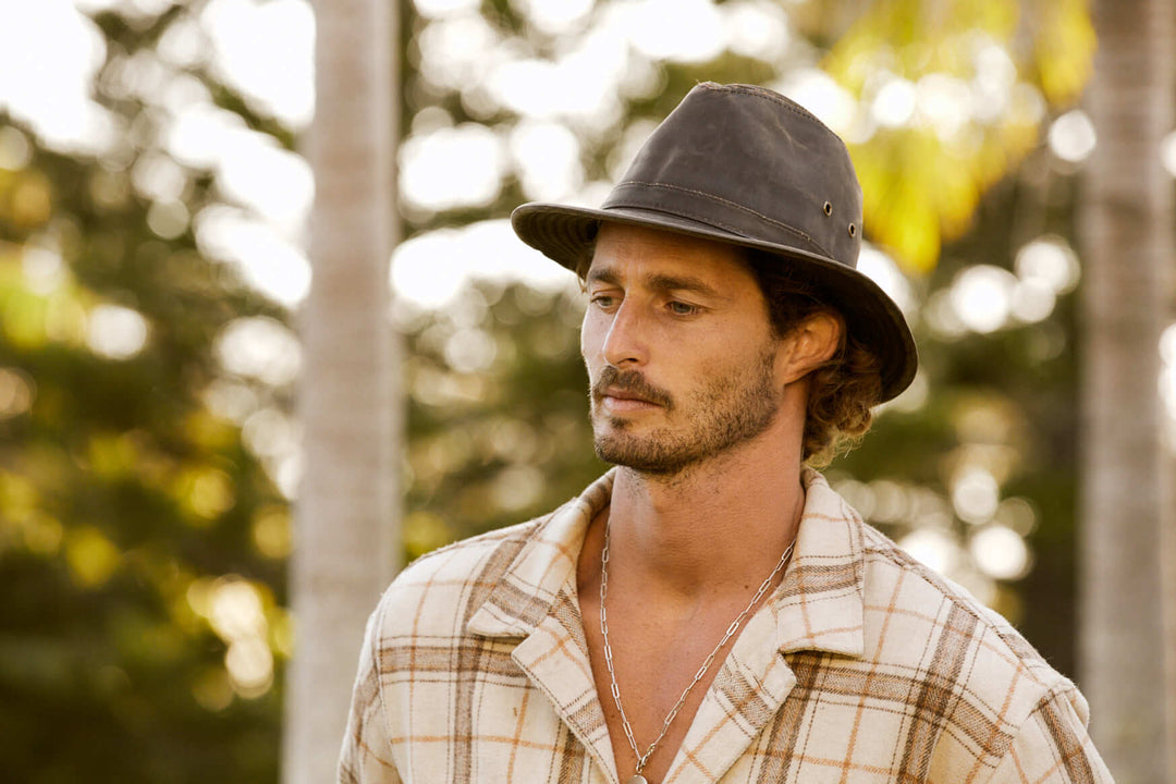 Man outside wearing Conner Hats cloth outback fedora style Indiana Jones hat in color Brown