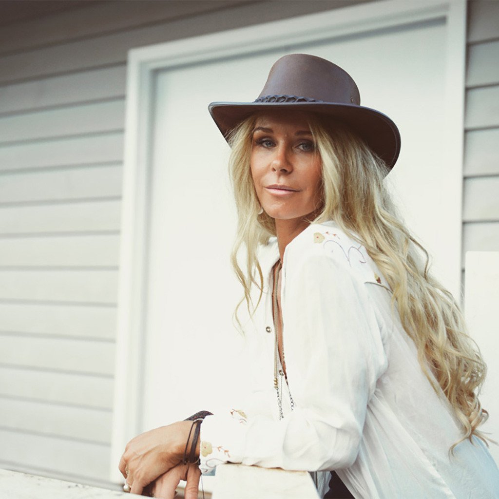 Woman in Aussie Bac Pac Traveller hat Handmade in Australia by BC Hats made from genuine oliy waterproof leather in color Brown