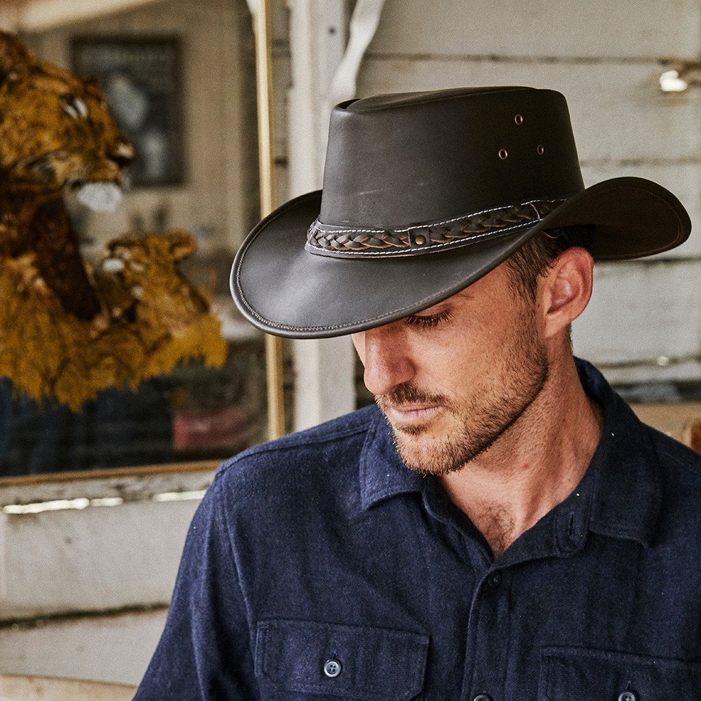 Man wearing Conner hats Down Under outback leather hat in color Black with three eyelets for ventilation and sewn on braided hat band for a unique look