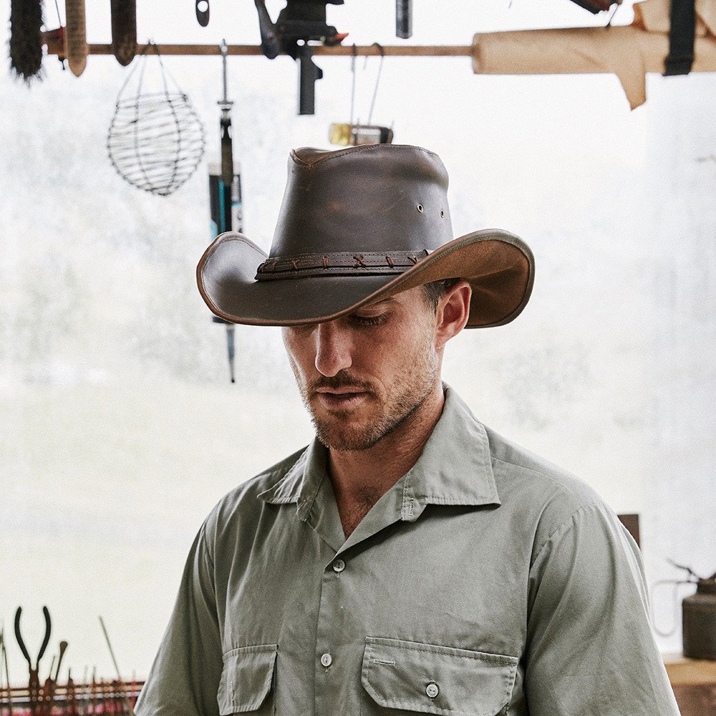 Man wearing Conner hats High Sierra leather outback and western style hat with shapeable brim in color Brown