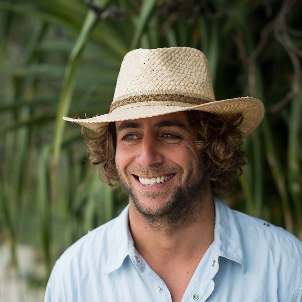 Man outdoors in Conner hats Key Largo sustainable raffia straw outback hats in Natural color