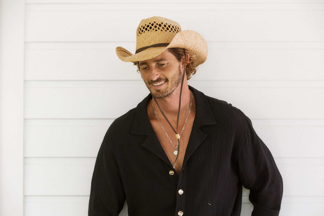 Man standing outside in Conner Hats jasper straw western hat cattleman crown with vented crown and leather chin cord