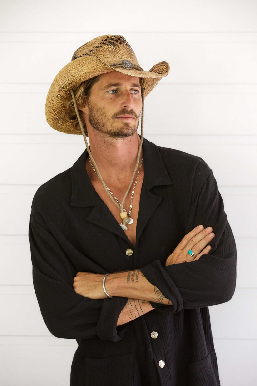 Man standing in Conner Hats John Stone hand braided raffia straw western hat with vented crown in Coffee color