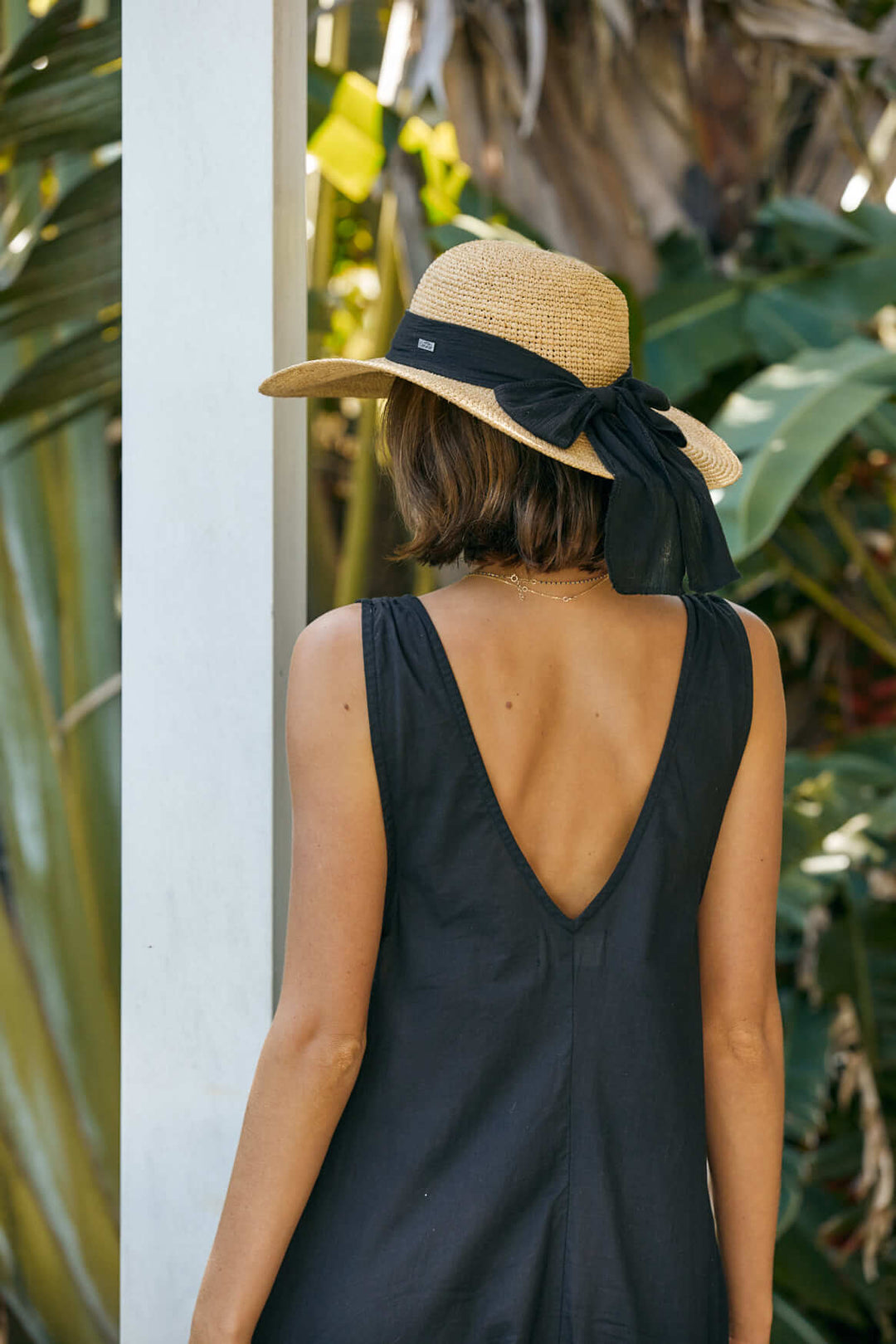 ladies raffia straw sun hat with wide elegant crocheted brim showing a bow at the back