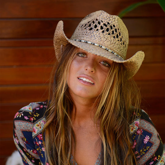 Girl in colored shirt wearing straw women's western Hat with pearl and silver colored beads and chin cord