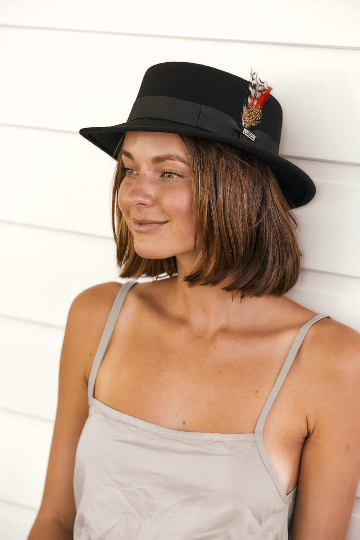 Woman wearing Black fedora with feather accent