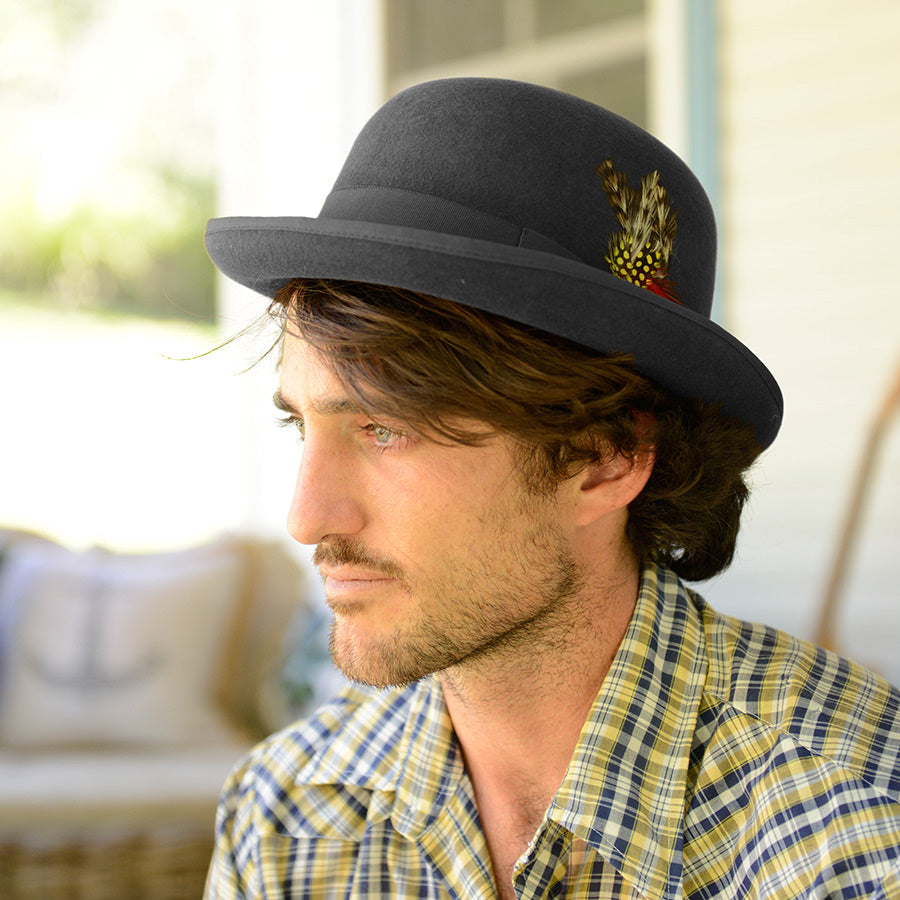 Man wearing Conner hats Humphrey wool Bowler/Derby hat in color back with feather trim and grosgrain band and trim