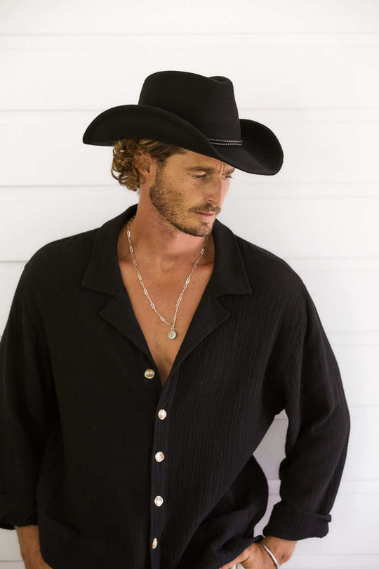 Man wearing Black shirt in western wool hat with shapable brim and braided hat band